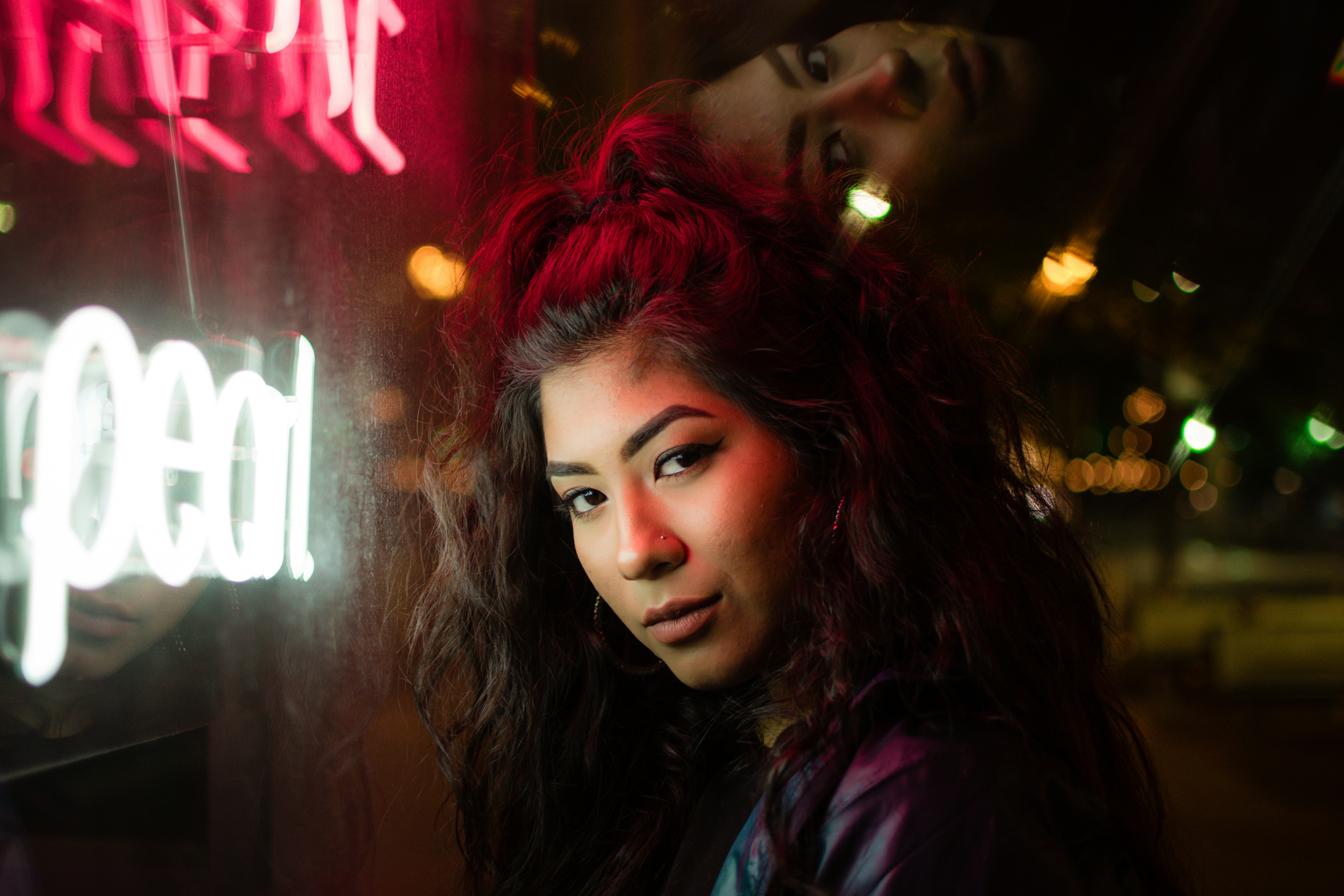 woman standing near neon signages